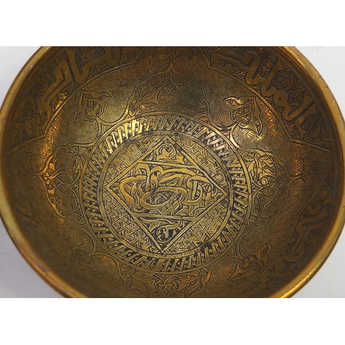 449 - Islamic Cairoware engraved with calligraphy and flowers including four bowls and a teapot, the large... 