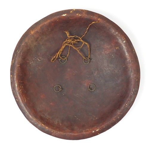 410A - Indo-Persian leather Dhal shield gilded with flowers, 43cm in diameter