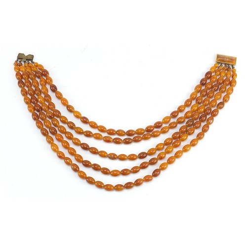 121 - Butterscotch amber coloured graduated five row necklace, the shortest row 40cm in length, total 124.... 