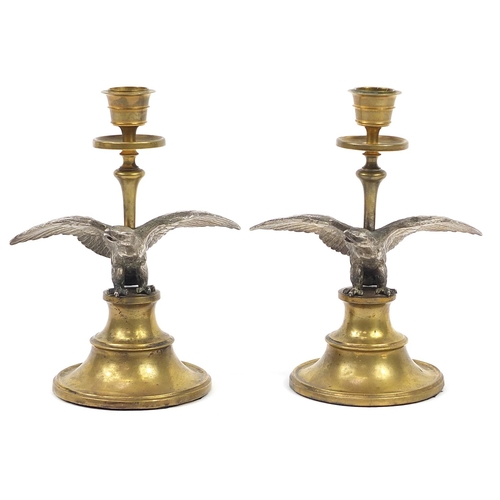 39 - Pair of 19th century brass and silver plated eagle design candlesticks, each 19cm high