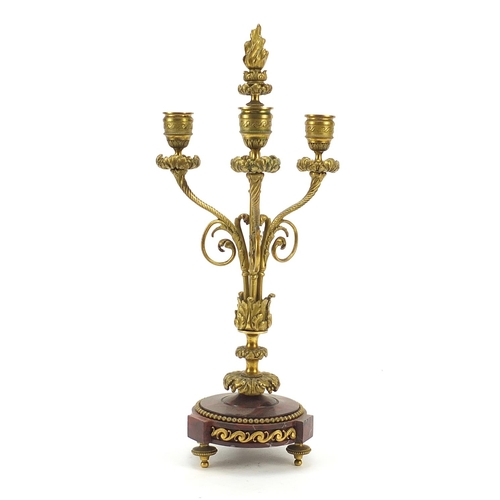 38 - 19th century French gilt metal and red marble three branch candelabra, 42cm high