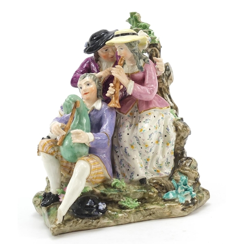 19 - Meissen, 18th century porcelain figure group of three musicians beside a tree playing the shawm and ... 