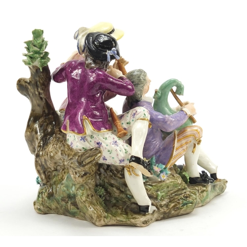 19 - Meissen, 18th century porcelain figure group of three musicians beside a tree playing the shawm and ... 