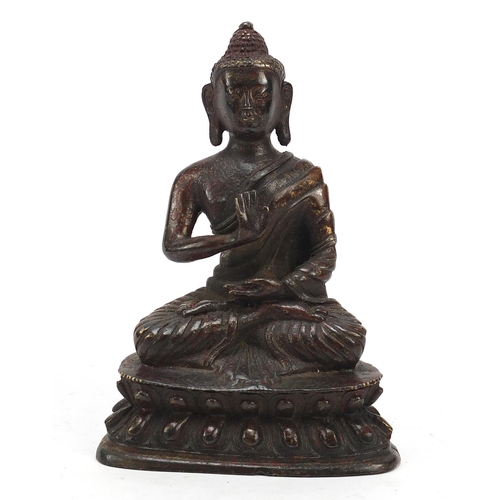 69 - Chino-Tibetan partially gilt bronze figure of seated Buddha with remnants of red paint 15.5cm high