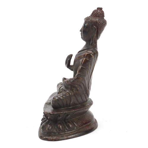 69 - Chino-Tibetan partially gilt bronze figure of seated Buddha with remnants of red paint 15.5cm high