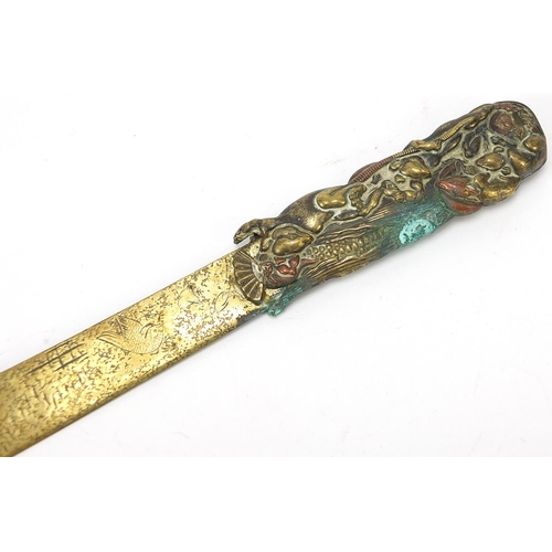 70 - Japanese mixed metal bronzed letter opener and a vesta case embossed with birds amongst trees, the l... 