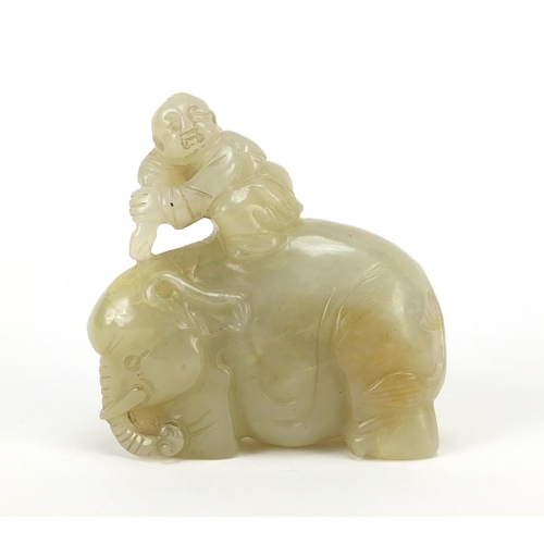 250 - Chinese celadon and russet jade carving of a boy holding a ruyi sceptre on elephant, 6.5cm wide