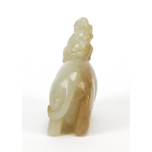 250 - Chinese celadon and russet jade carving of a boy holding a ruyi sceptre on elephant, 6.5cm wide