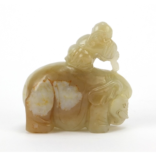 250 - Chinese celadon and russet jade carving of a boy holding a ruyi sceptre on elephant, 6.5cm wide