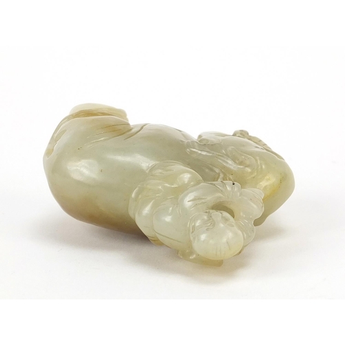 250 - Chinese celadon and russet jade carving of a boy holding a ruyi sceptre on elephant, 6.5cm wide