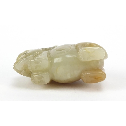 250 - Chinese celadon and russet jade carving of a boy holding a ruyi sceptre on elephant, 6.5cm wide