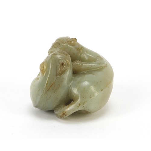 72 - Good Chinese celadon and russet jade carving of two mythical animals, 4.5cm wide