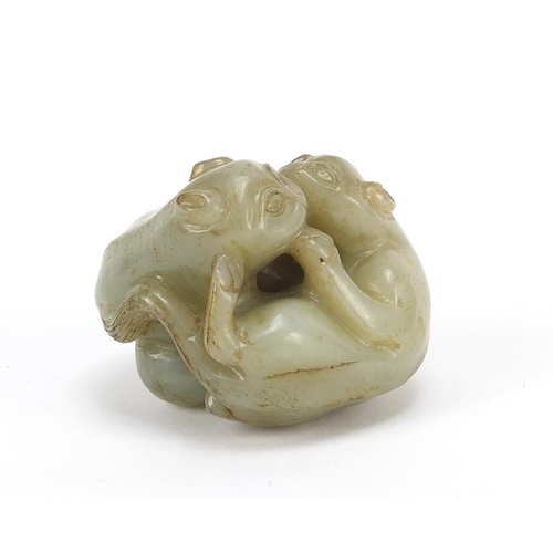 72 - Good Chinese celadon and russet jade carving of two mythical animals, 4.5cm wide