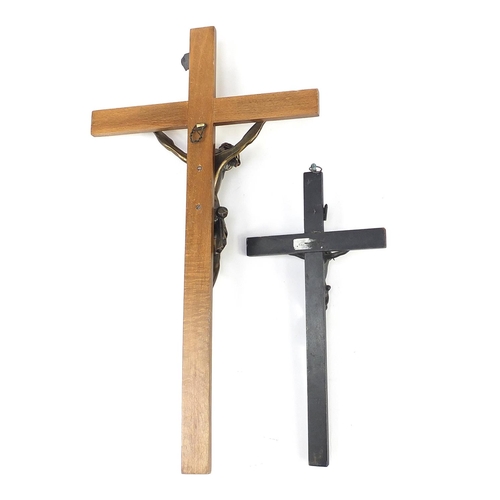 139 - Two religious crucifixes each with applied bronzed Christ, the largest 50cm high