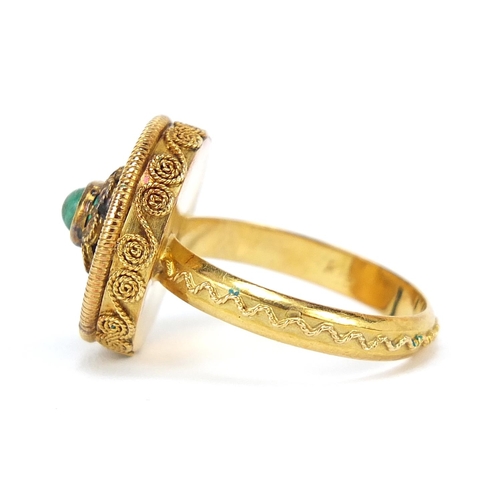 266 - Continental 18ct gold ring with ornate setting and band, set with a cabochon green stone, size M, 5.... 