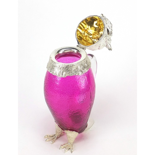 689 - Novelty cranberry glass owl jug with silver plated mounts and beaded glass eyes, 29cm high