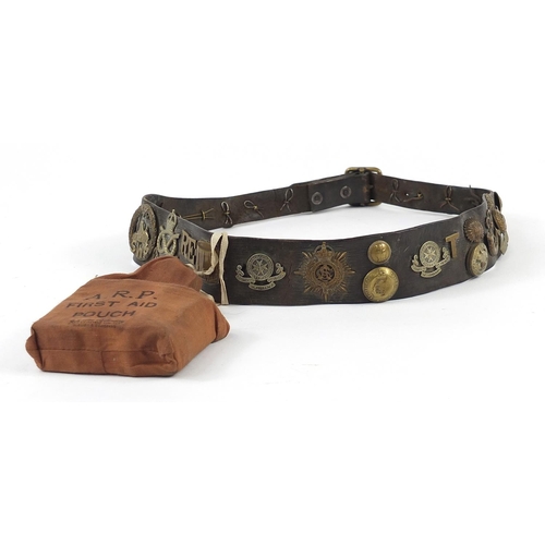 1453 - British military leather belt with cap badges, buttons and ARP first aid pouch, the belt 94.5cm in l... 