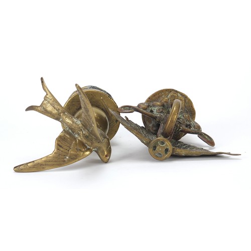 133 - Two antique brass car mascots including one in the form of a swallow, the largest 14cm high