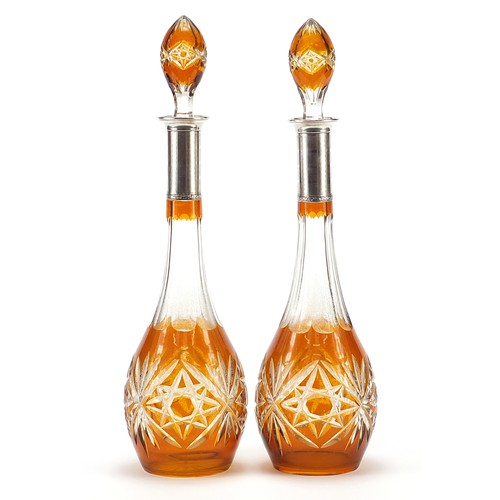 296 - Pair of Bohemian amber flashed cut glass decanters with silver collars, each 43cm high