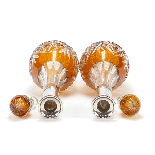 296 - Pair of Bohemian amber flashed cut glass decanters with silver collars, each 43cm high