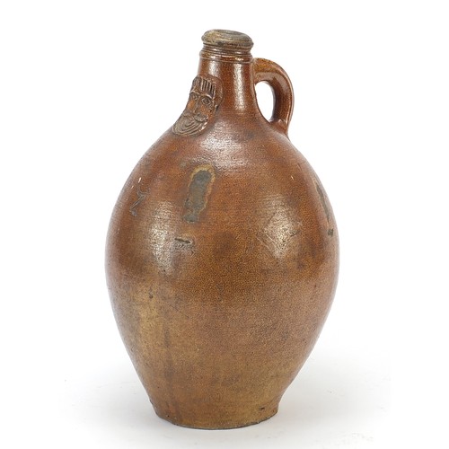 294 - 17th century large antique salt glazed Bellamine jug with mask, 35cm high