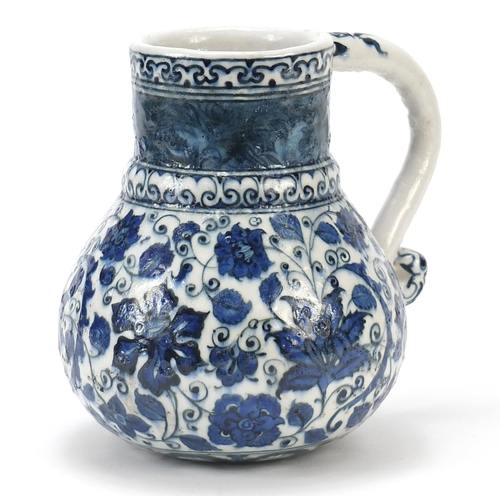 223 - Turkish Iznik water jug with handle, hand painted with flowers and foliage, 19.5cm high