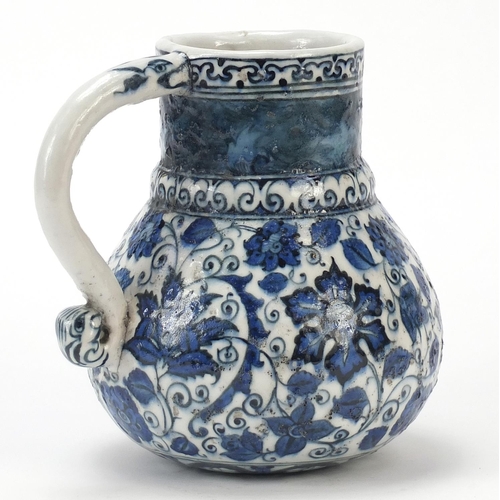 223 - Turkish Iznik water jug with handle, hand painted with flowers and foliage, 19.5cm high