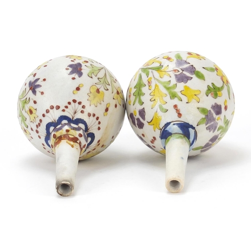 131 - Pair of Islamic rosewater sprinklers hand painted with flowers, each 15.5cm high