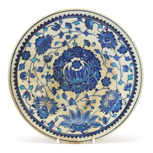 394 - Turkish Kutahya plate hand painted with flowers, possibly Ottoman, 21.5cm in diameter