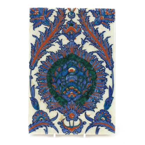 129 - Turkish Iznik tile hand fragment painted with flowers and foliage, 24cm x 16.5cm