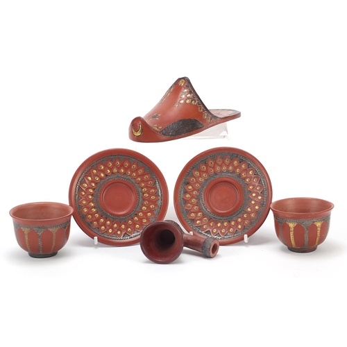 226 - Turkish Tophane terracotta comprising a slipper, two tea bowls with saucers and a pipe bowl, the lar... 