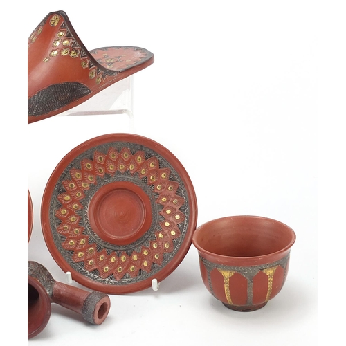 226 - Turkish Tophane terracotta comprising a slipper, two tea bowls with saucers and a pipe bowl, the lar... 