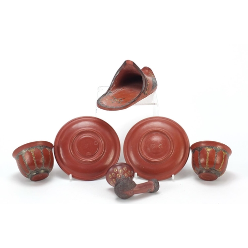 226 - Turkish Tophane terracotta comprising a slipper, two tea bowls with saucers and a pipe bowl, the lar... 