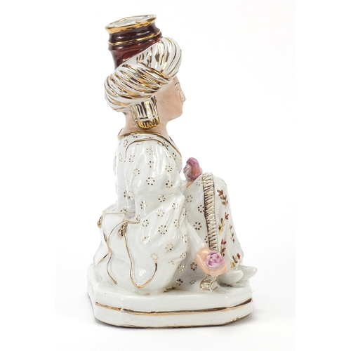 77 - Jacob Petit, French porcelain figural candlestick of a Turkish female holding a bird and flower, 22c... 