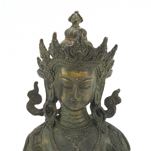 567 - Chino Tibetan patinated bronze figure of Buddha, 29cm high