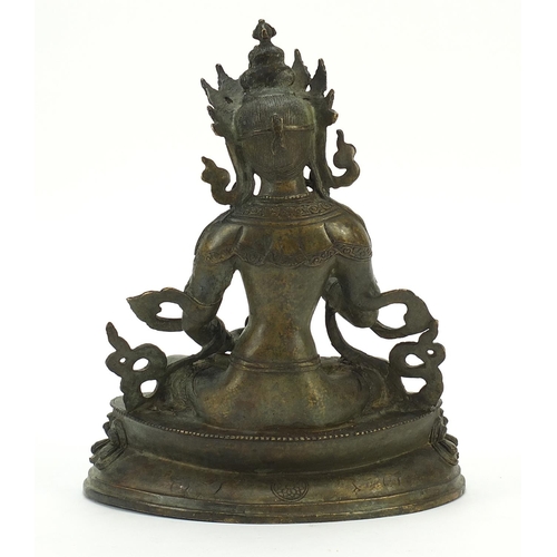 567 - Chino Tibetan patinated bronze figure of Buddha, 29cm high