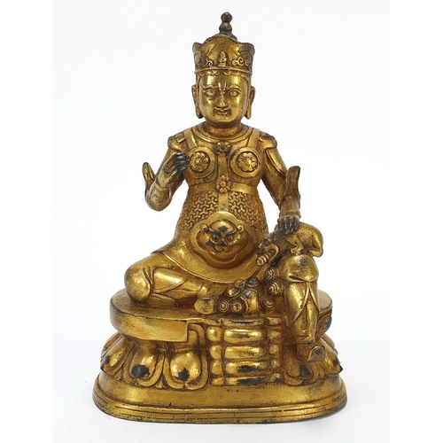 728 - Chino Tibetan gilt bronze mythical figure and animal, 26cm high