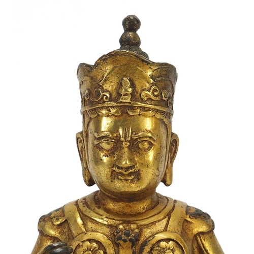 728 - Chino Tibetan gilt bronze mythical figure and animal, 26cm high