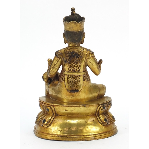 728 - Chino Tibetan gilt bronze mythical figure and animal, 26cm high