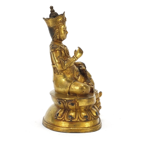 728 - Chino Tibetan gilt bronze mythical figure and animal, 26cm high