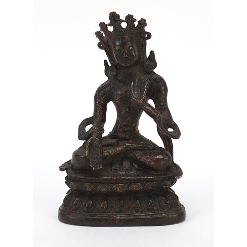 115 - Chino Tibetan bronze figure of Buddha with remnants of gilding and red paint, 15cm high