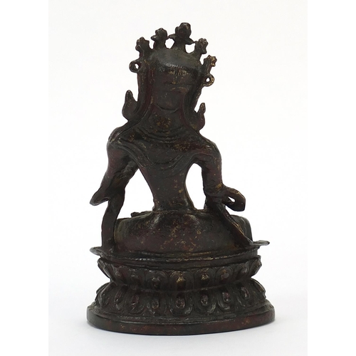 115 - Chino Tibetan bronze figure of Buddha with remnants of gilding and red paint, 15cm high