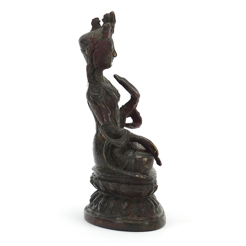 115 - Chino Tibetan bronze figure of Buddha with remnants of gilding and red paint, 15cm high