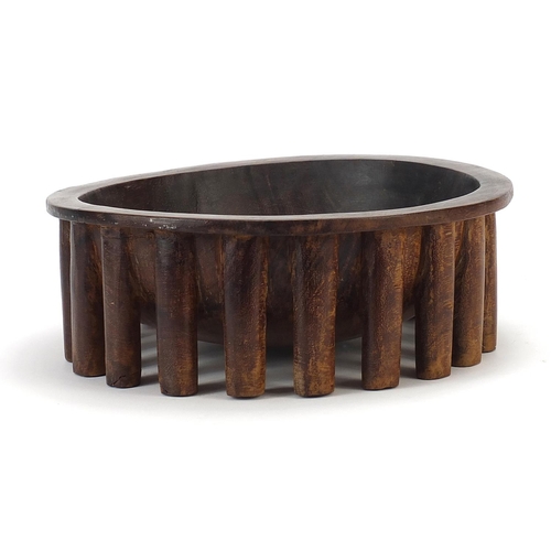 596 - African carved hardwood nupe design twenty legged bowl, 30cm in diameter