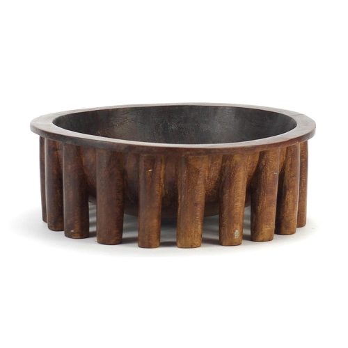 596 - African carved hardwood nupe design twenty legged bowl, 30cm in diameter