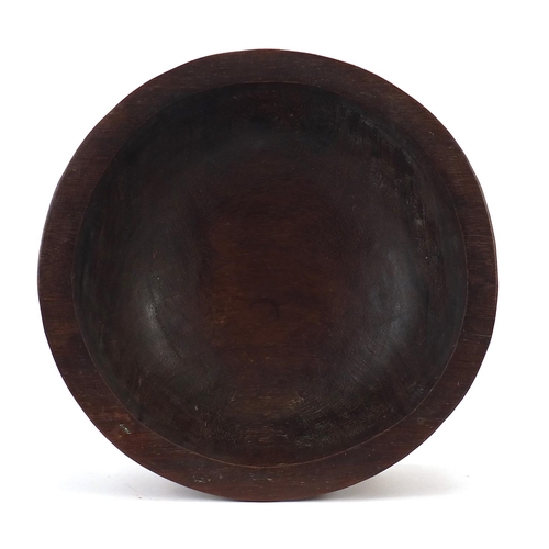 596 - African carved hardwood nupe design twenty legged bowl, 30cm in diameter