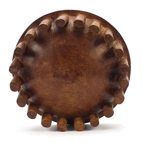 596 - African carved hardwood nupe design twenty legged bowl, 30cm in diameter