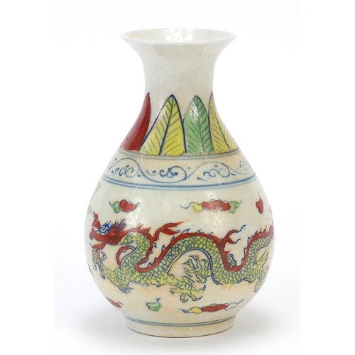 469 - Chinese porcelain vase decorated in the wucai palette with two dragons amongst clouds, six figure ch... 