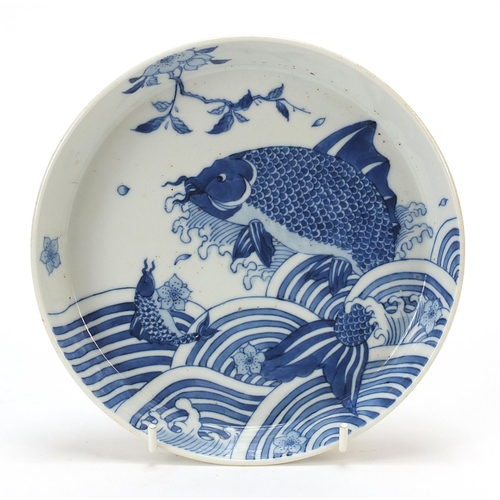 270 - Chinese blue and white porcelain footed dish hand painted with fish amongst waves, six figure charac... 