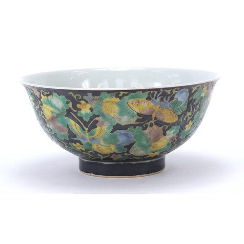 277 - Chinese porcelain footed bowl hand painted in the famille noir palette with butterflies amongst flow... 